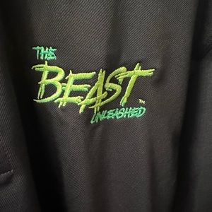 Nike black polo with left arm logo. Front of shirt has BEAST logo